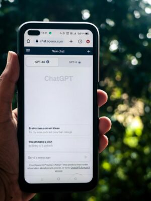 A person uses ChatGPT on a smartphone outdoors, showcasing technology in daily life.